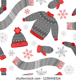Gray and red winter clothes and snowflakes on a white background. Cap, sweater and socks. Seamless vector pattern