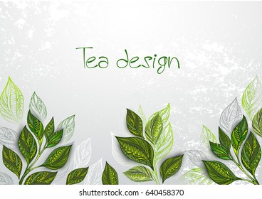 Gray, textured background with green tea leaves.