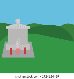gray tombstone with red candles and incense on grass and in the background green hills against the blue sky