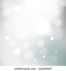 Gray winter background with snowflakes 