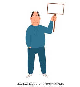 A gray-haired man in a tracksuit with a sign for the text in his hand.