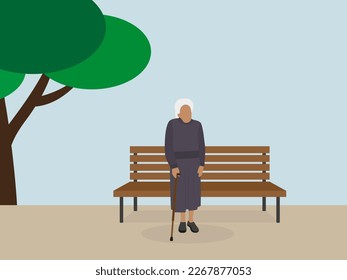 A gray-haired old woman with a cane standing next to a wooden bench outdoors