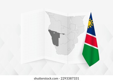 A grayscale map of Namibia with a hanging Namibian flag on one side. Vector map for many types of news. Vector illustration.