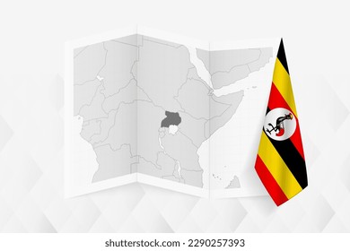 A grayscale map of Uganda with a hanging Ugandan flag on one side. Vector map for many types of news. Vector illustration.