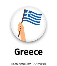 Greece flag in hand, round icon with shadow isolated on white. Human hand holding flag, vector illustration