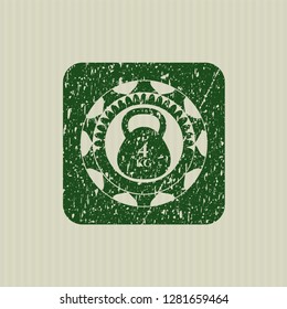 Green 4kg kettlebell icon inside distress rubber stamp