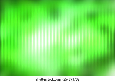 Green abstract blur colored background with defocused vertical rays of light.