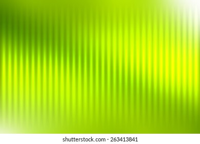 Green abstract blur colored background with defocused vertical rays of light.