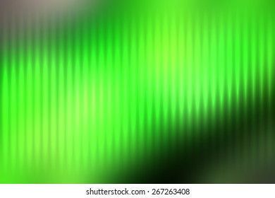 Green abstract blur colored background with defocused vertical rays of light.