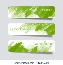 Green abstract paper banners / stickers / badges with hand painted brush strokes background