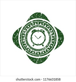 Green alarm clock icon inside distressed rubber grunge seal
