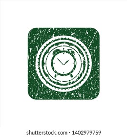 Green alarm clock icon inside distress rubber seal with grunge texture