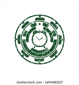 Icono de reloj despertador verde dentro de un sello de textura de hule de goma con grifo
