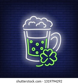 Green ale in mug and clover neon sign. Saint Patricks Day design. Night bright neon sign, colorful billboard, light banner. Vector illustration in neon style.