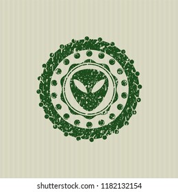 Green alien icon with rubber seal texture