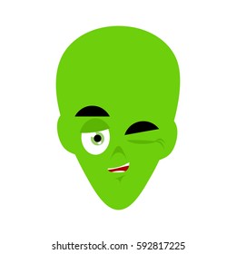 Green alien winks Emoji. UFO face happy emotion
