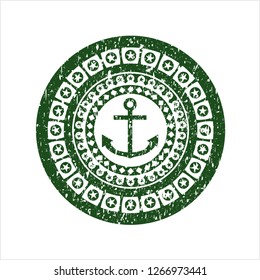 Green anchor icon inside distressed rubber seal with grunge texture