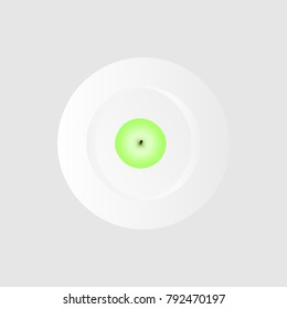 
Green apple on top on a plate
