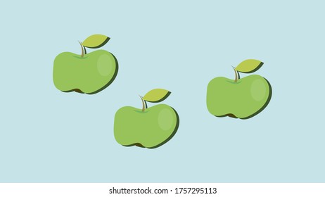 Green apples on a light blue background