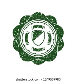 Green armor icon inside distress rubber seal with grunge texture