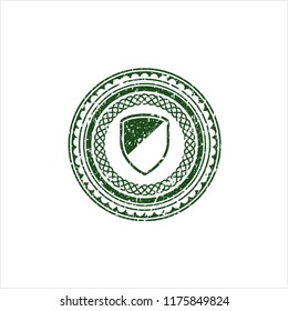 Green armor icon inside rubber grunge seal