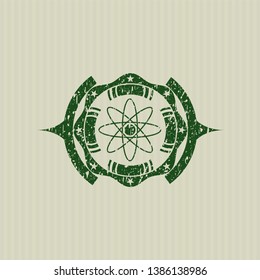 Green atom icon inside distress rubber stamp with grunge texture