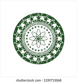 Green atom icon inside distressed grunge stamp