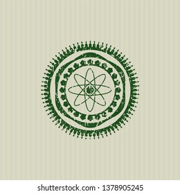 Green atom icon inside rubber grunge seal