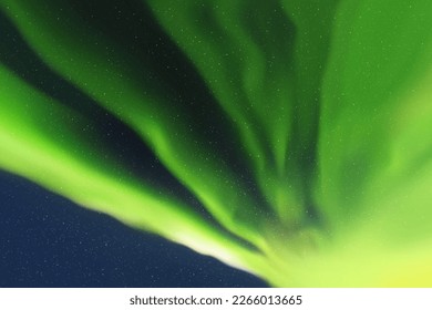 Green aurora borealis. Dark night starry sky and Northern lights