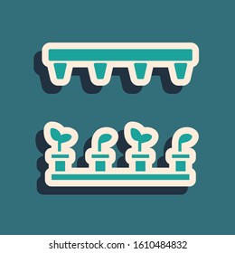 Green Automatic irrigation sprinklers icon isolated on blue background. Watering equipment. Garden element. Spray gun icon. Long shadow style. Vector Illustration