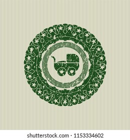 Green baby cart icon inside distressed grunge stamp