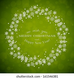 Green background with Christmas wreath made from snowflakes