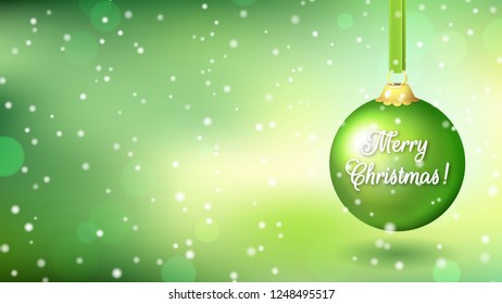 Green background with a large green Christmas ball and the inscription Merry Christmas. Wide screen
