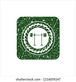 Green barbell on rack icon inside rubber grunge seal