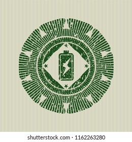 Green battery charging icon inside distressed rubber seal