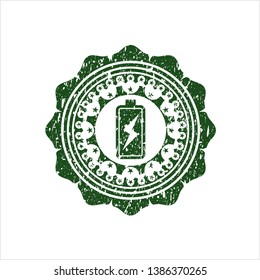 Green battery charging icon inside rubber texture