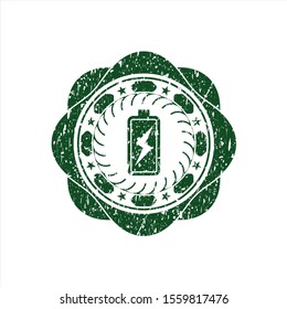 Green battery charging icon inside distressed rubber stamp