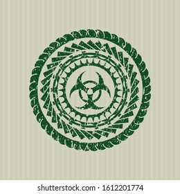 Green biohazard icon inside distressed rubber stamp