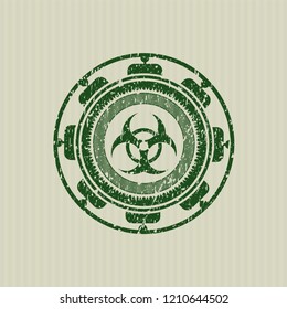 Green biohazard icon inside rubber grunge texture stamp
