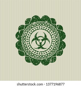 Green biohazard icon inside rubber grunge stamp