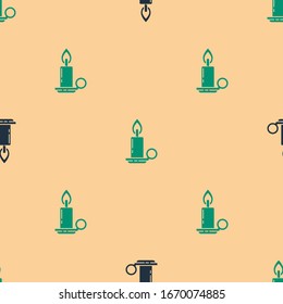Green and black Burning candle in candlestick icon isolated seamless pattern on beige background. Cylindrical candle stick with burning flame.  Vector Illustration