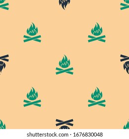 Green and black Campfire icon isolated seamless pattern on beige background. Burning bonfire with wood.  Vector Illustration