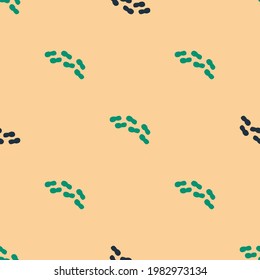 Green and black Human footprints shoes icon isolated seamless pattern on beige background. Shoes sole.  Vector