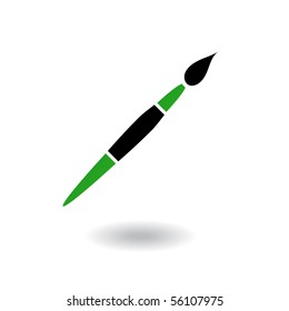 Green and black paintbrush isolated on white