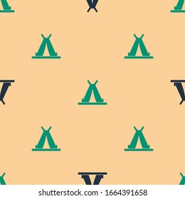 Green and black Traditional indian teepee or wigwam icon isolated seamless pattern on beige background. Indian tent.  Vector Illustration