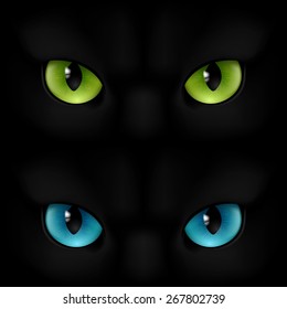 Green and blue cats eyes on a black background