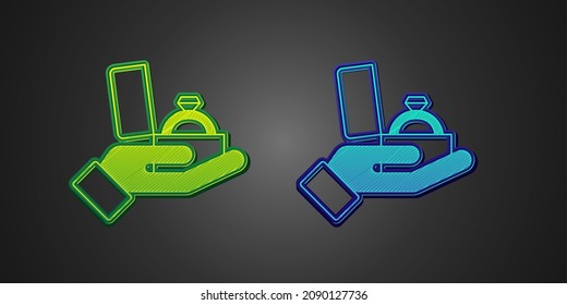 Green and blue Diamond engagement ring in a box icon isolated on black background.  Vector