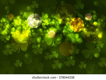 Green blurred bokeh background with clovers. St. Patrick Day vector design