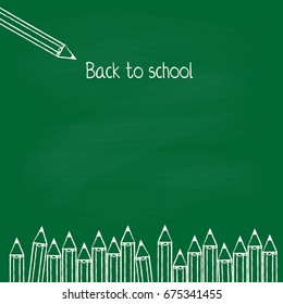 Green board with white chalked crayons