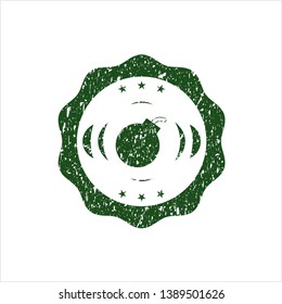 Green bomb icon inside distressed rubber grunge stamp